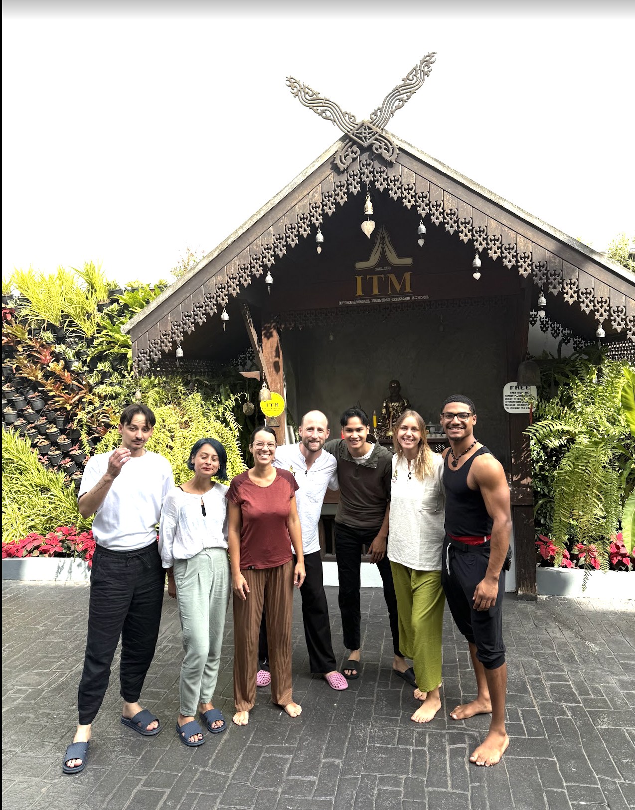 Elijah Naylor Jr. with wellness classmates outside a Thai medicine school