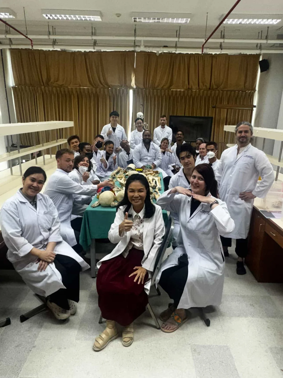 Anatomy course participants and instructors in the laboratory with skeletal teaching specimens