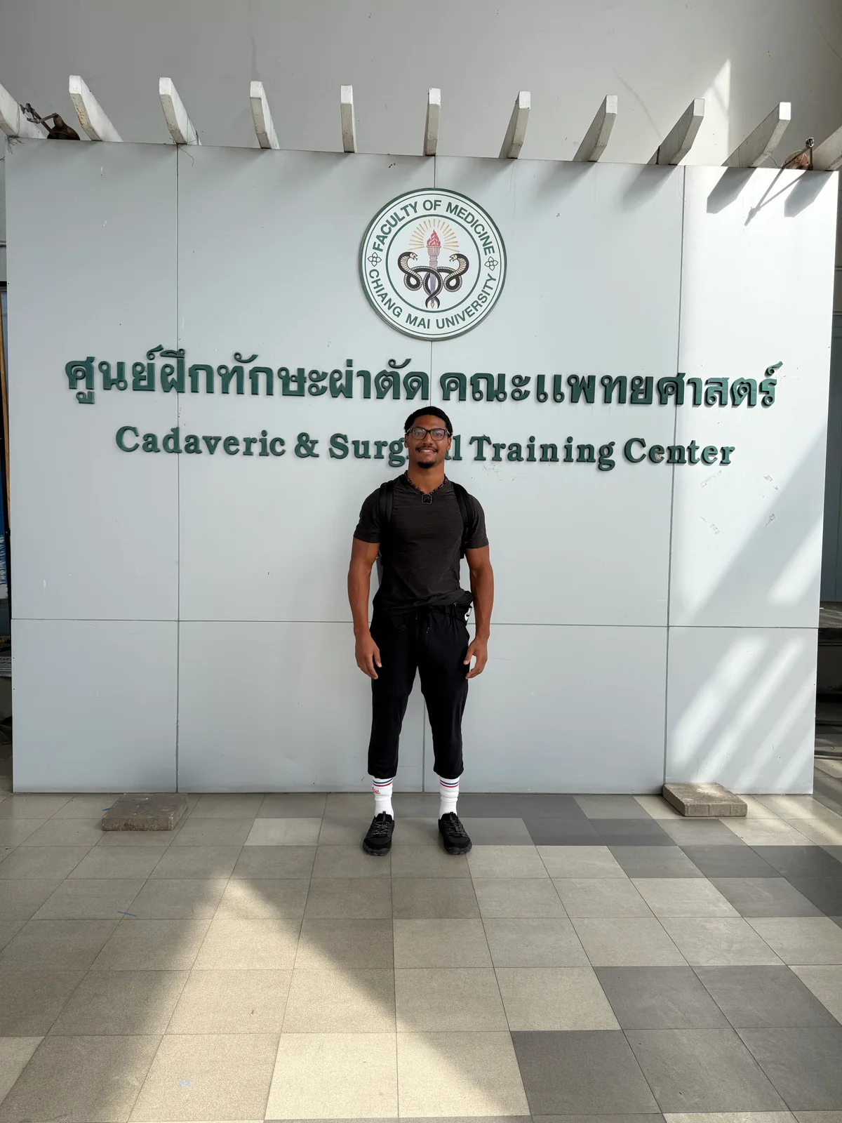 Elijah outside the Cadaveric and Surgical Training Center at Chiang Mai University